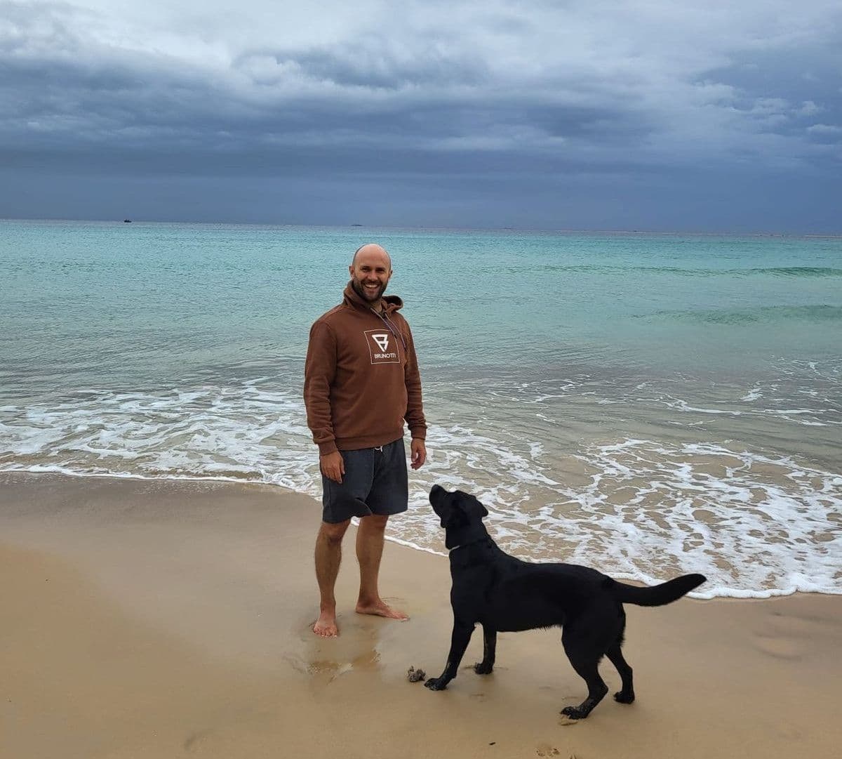 Milan with dog on the beach